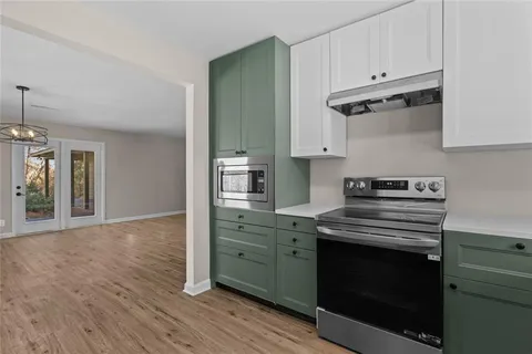 a kitchen with cabinets wooden floor and a sink