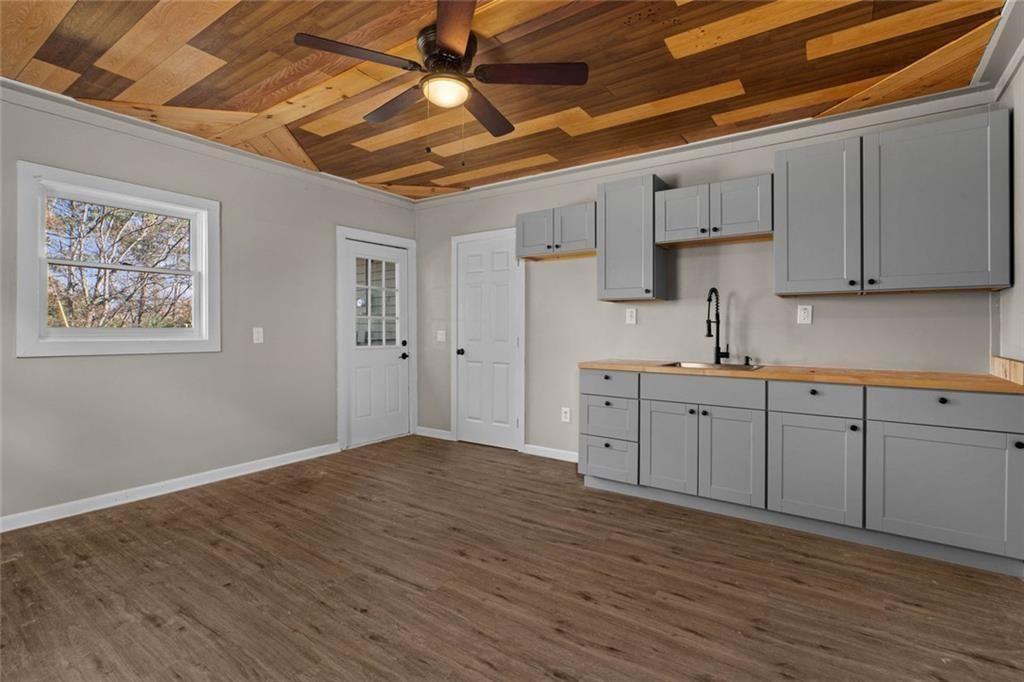 345 Roland Drive Canton, GA 30114 - Photo 30 of 44 a kitchen with cabinets wooden floor and a sink