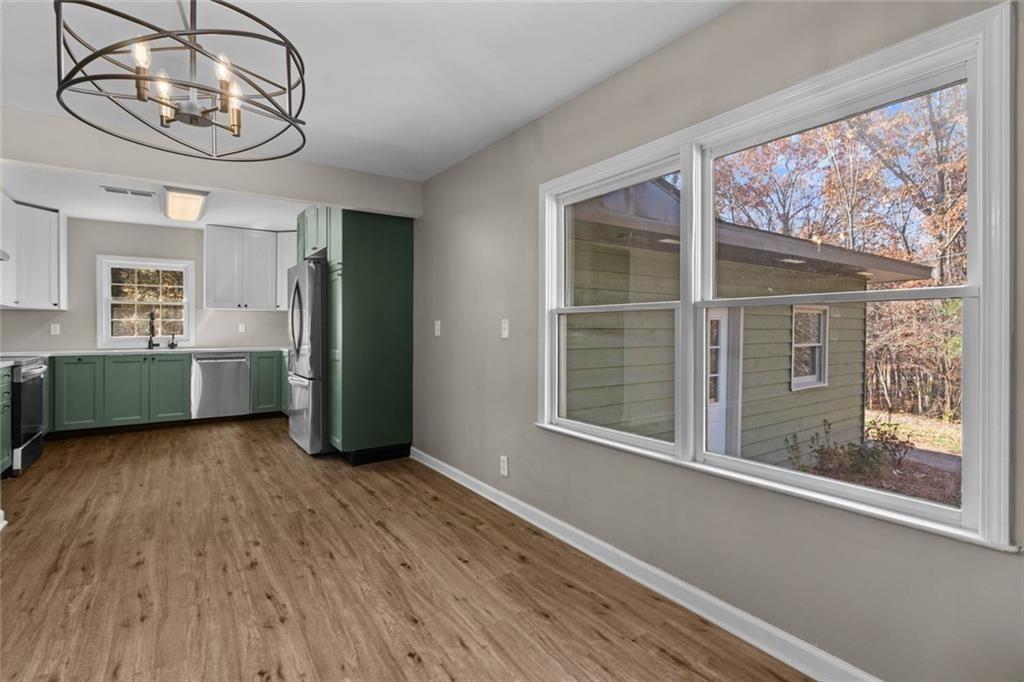 345 Roland Drive Canton, GA 30114 - Photo 32 of 44 a view of an empty room with a window and wooden floor
