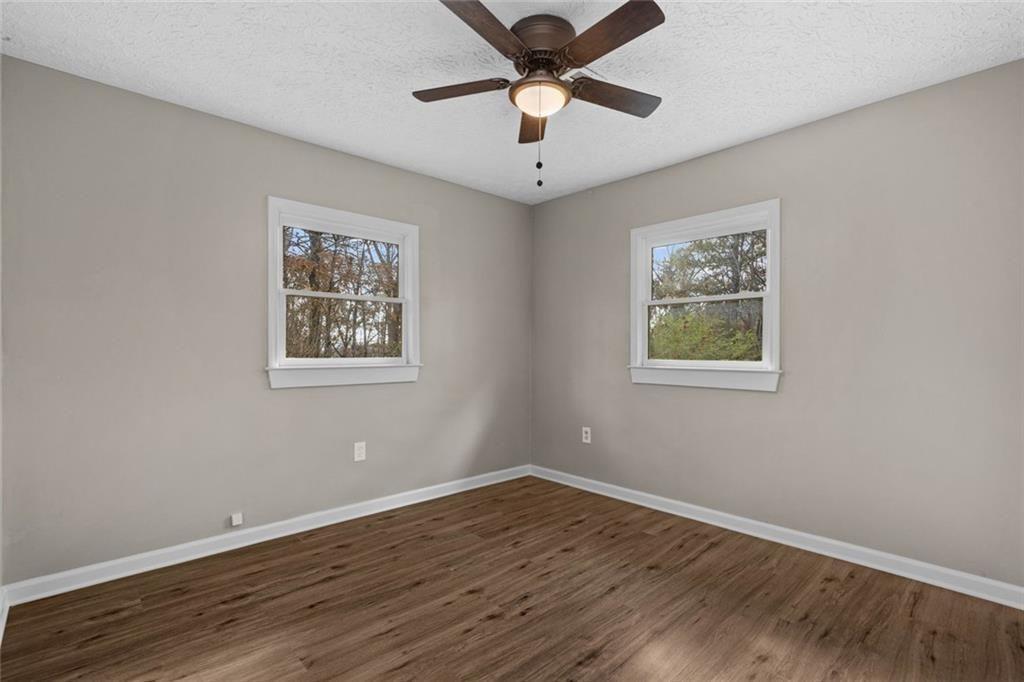 345 Roland Drive Canton, GA 30114 - Photo 36 of 44 a view of empty room with wooden floor and fan
