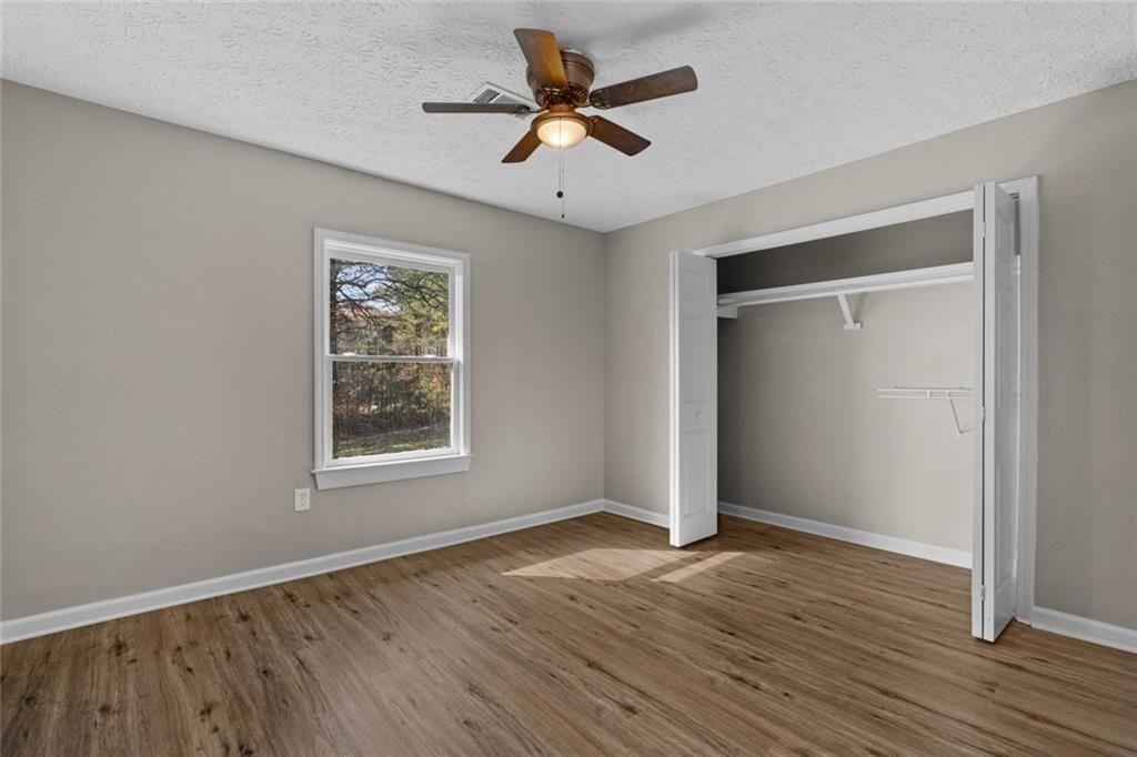 345 Roland Drive Canton, GA 30114 - Photo 38 of 44 an empty room with wooden floor and windows