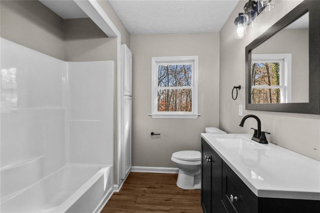 345 Roland Drive Canton, GA 30114 - Photo 41 of 44 a bathroom with a sink a toilet and shower