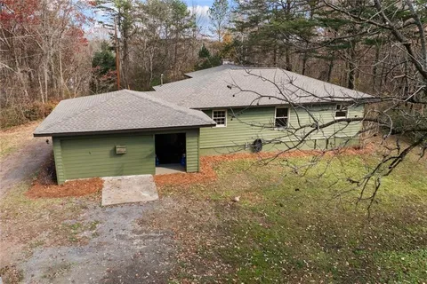 an aerial view of a house with yard and parking