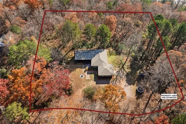 an aerial view of a house with a yard basket ball court and outdoor seating
