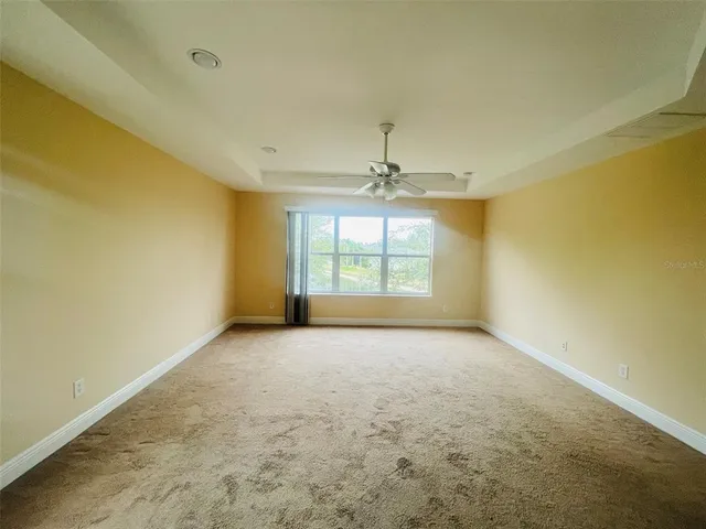 an empty room with a empty space and windows