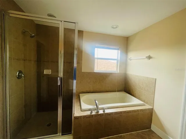 a bathroom with a tub and a shower
