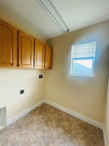a view of a livingroom with wooden floor and a window