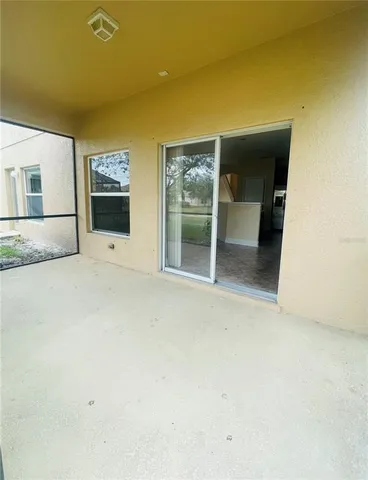 an empty room with a fireplace and a window