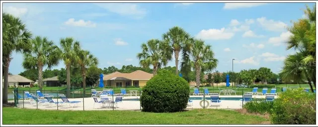 a view of a house with garden and a patio