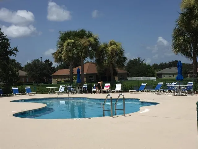 a view of a swimming pool with a table and chairs