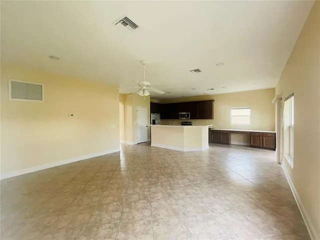 a view of a kitchen with a sink and a refrigerator