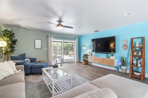 a living room with furniture wooden floor and window