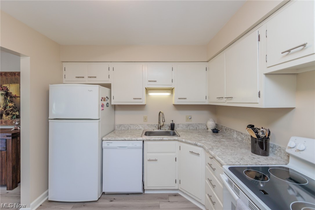 1750 Wagar Road, Unit 206 Rocky River, OH 44116 - Photo 19 of 33 Kitchen featuring light countertops, new dishwasher, white appliances.