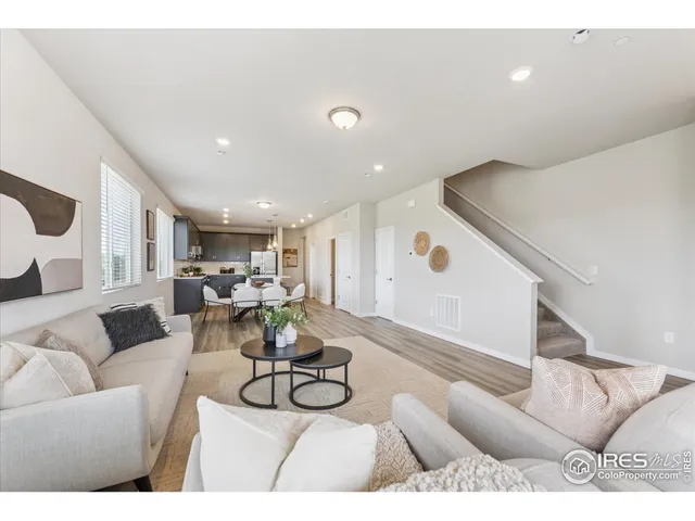 a living room with furniture and kitchen view