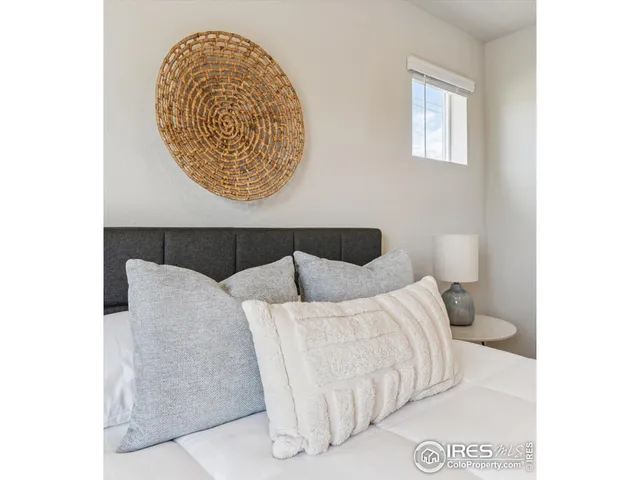 a bedroom with a bed and a painting on the wall