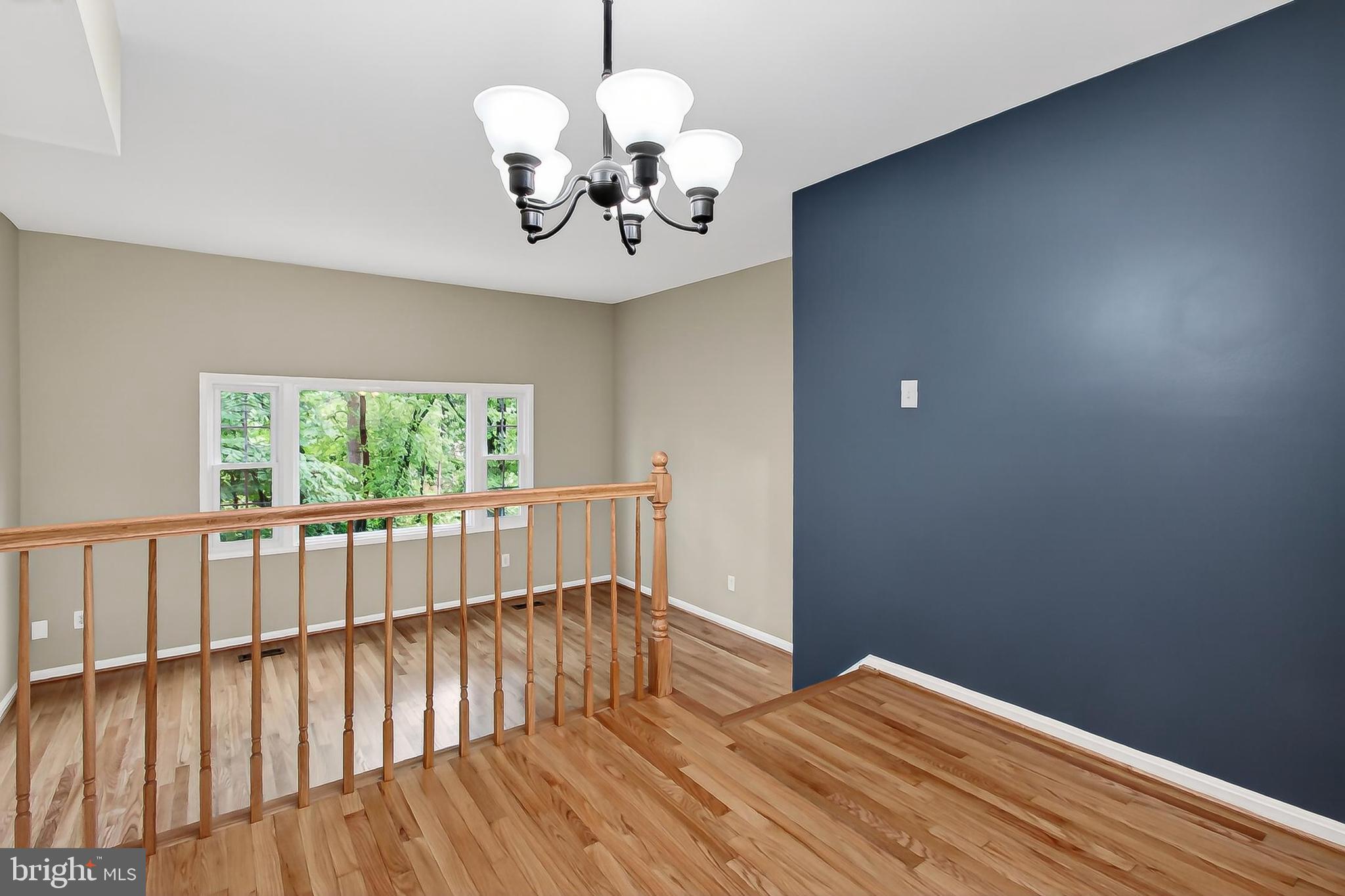 5833 Royal Ridge Drive, Unit 943 Springfield, VA 22152 - Photo 13 of 45 a view of a room with wooden floor chandelier and windows