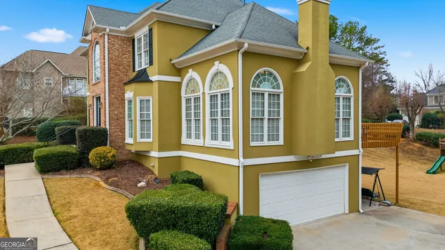 a front view of a house with garden