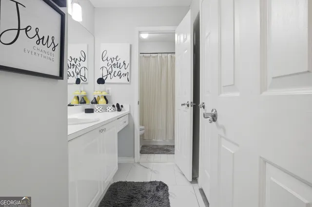 a bathroom with a tub sink and mirror