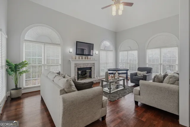 a living room with furniture fireplace and a table
