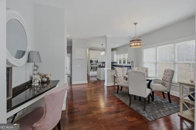 a view of a swimming pool with seating area and trees in the background