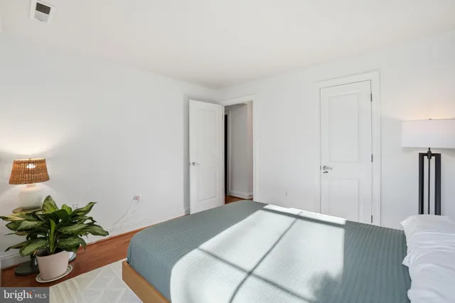 a bedroom with a bed and a potted plant