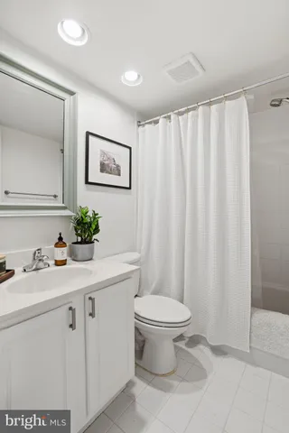 a bathroom with a sink toilet and a mirror