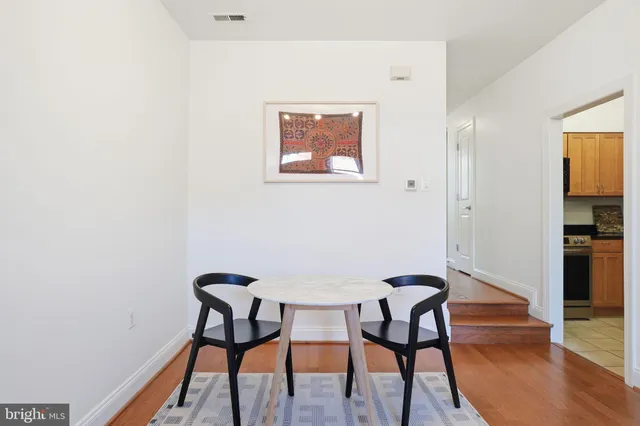 a view of a workspace with furniture and wooden floor