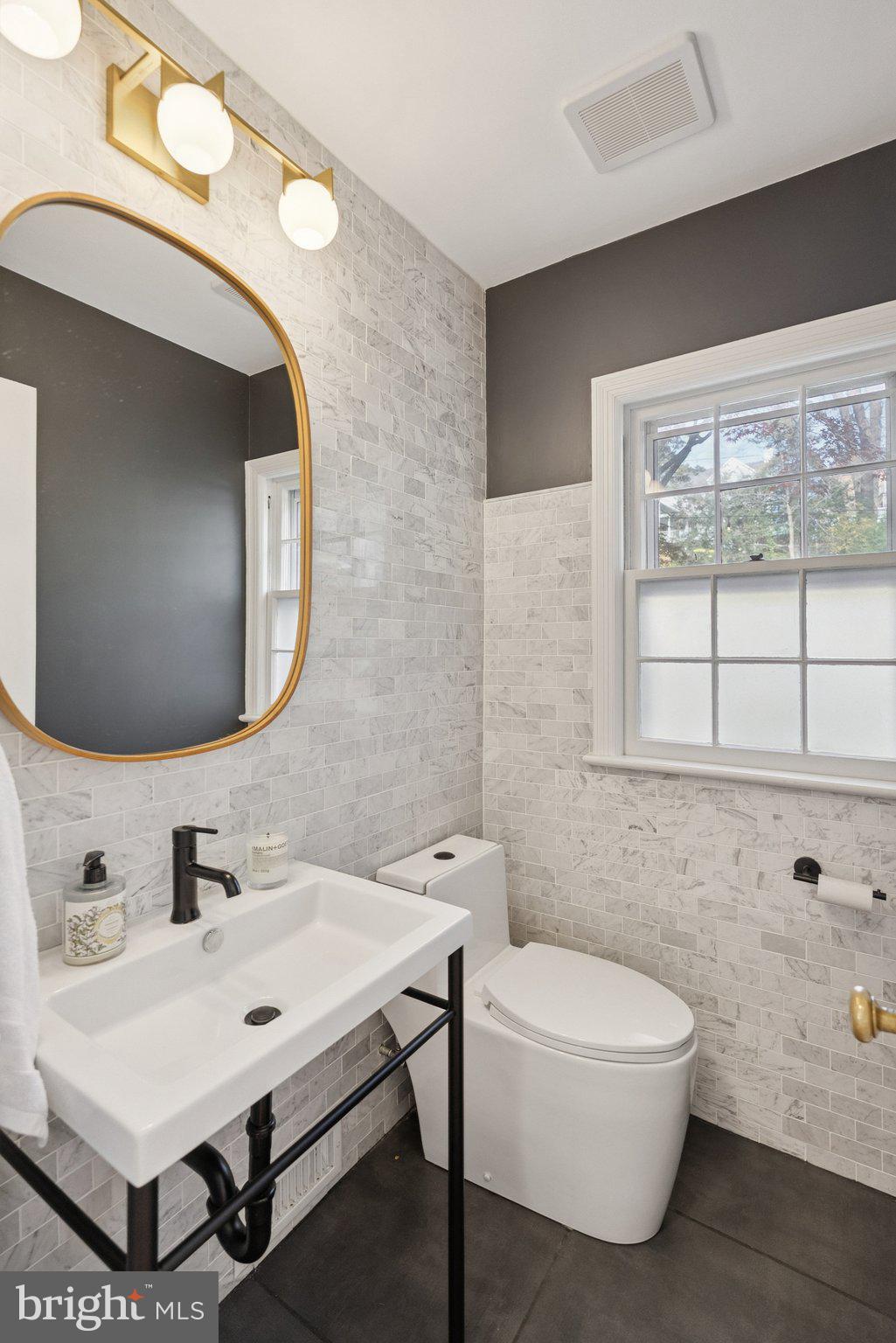 3231 Beech Street Northwest Washington, DC 20015 - Photo 11 of 29 a bathroom with a sink mirror and a bathtub