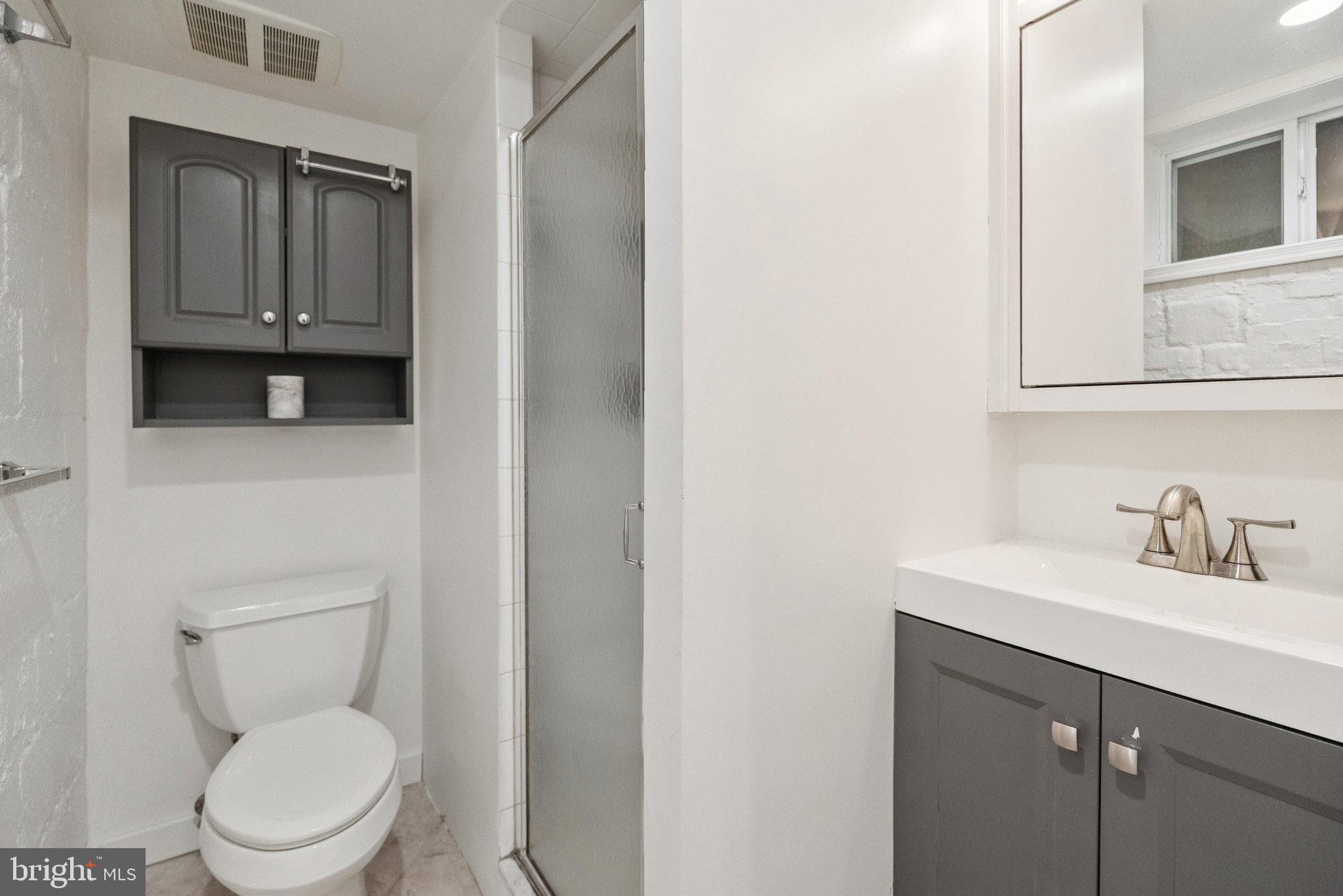 3231 Beech Street Northwest Washington, DC 20015 - Photo 21 of 29 a bathroom with a toilet a sink a vanity and mirror