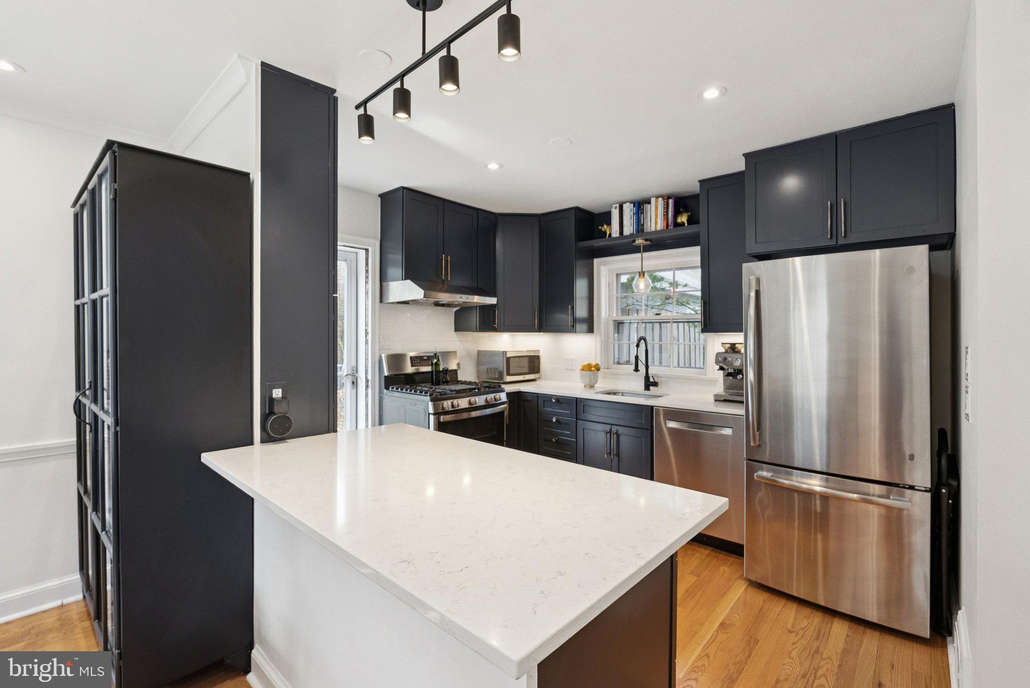 3231 Beech Street Northwest Washington, DC 20015 - Photo 10 of 29 a kitchen with stainless steel appliances a refrigerator sink and stove