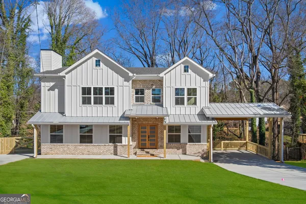 a front view of a residential apartment building with a yard