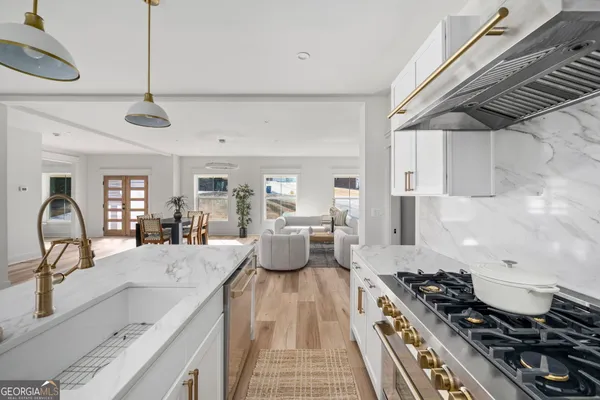a kitchen with a stove a sink and cabinets