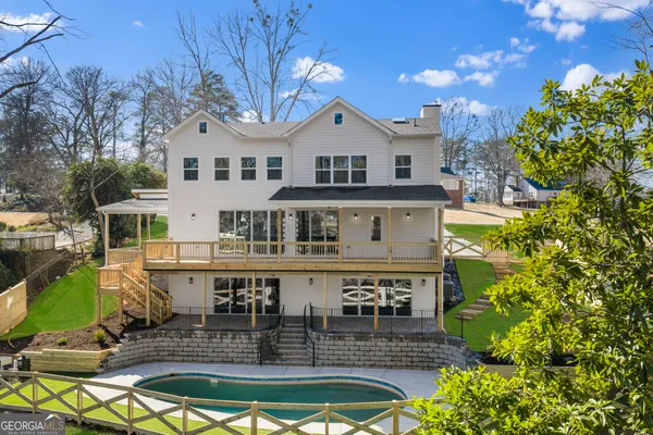 a aerial view of a house with swimming pool and sitting area