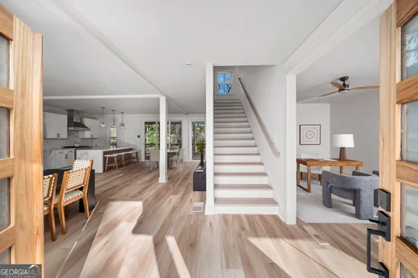 a view of a living room filled with furniture and wooden floor