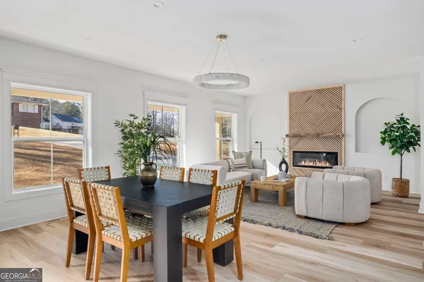 a view of a dining room with furniture window and wooden floor