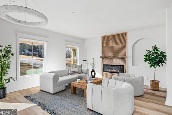 a living room with furniture potted plant and a window