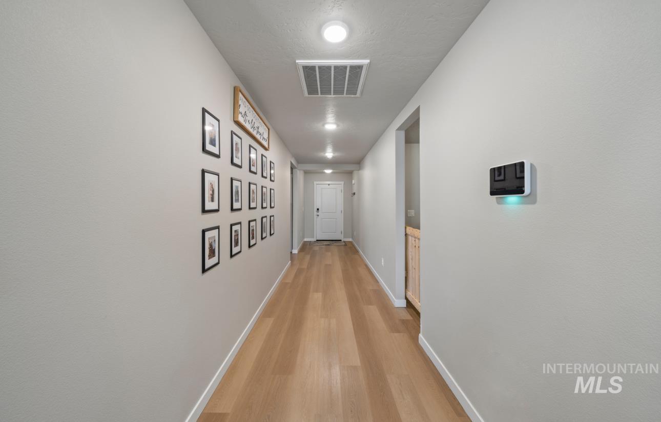 12443 Varga Street Caldwell, ID 83607 - Photo 15 of 27 Hallway with light wood-style flooring and recessed lighting