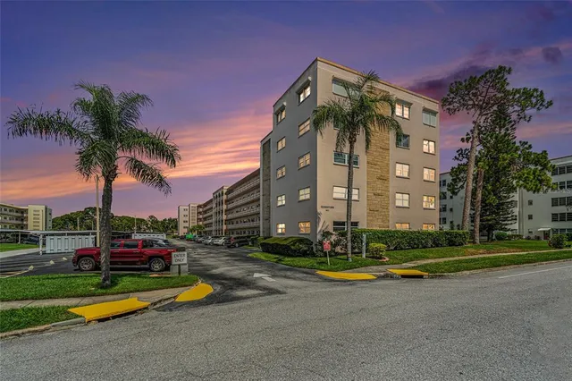 a view of a park with multi story residential apartment building in the background