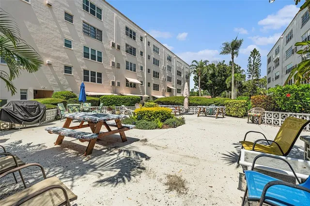a view of a building with sitting area and furniture