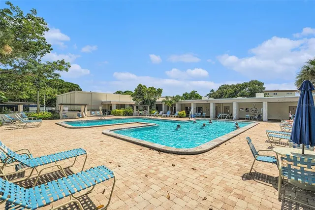 a swimming pool with outdoor seating and yard