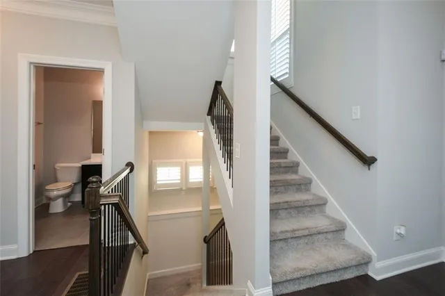 a bathroom with a sink toilet and mirror