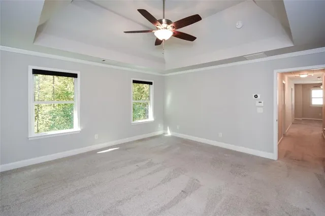 a view of empty room with cabinet and window