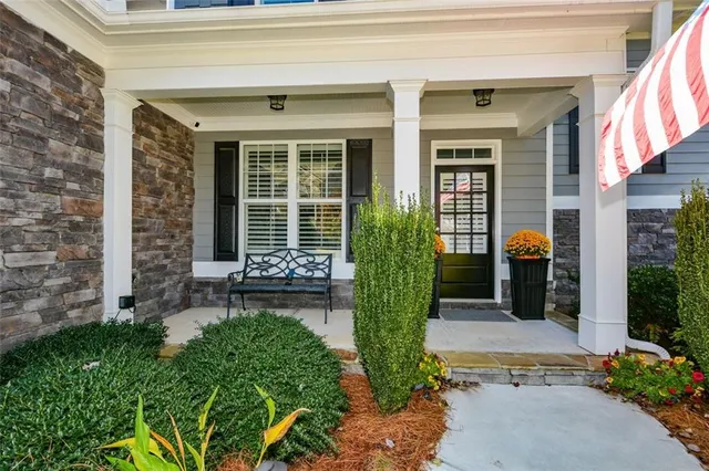 a kitchen with stainless steel appliances granite countertop wooden cabinets a stove a sink and a refrigerator