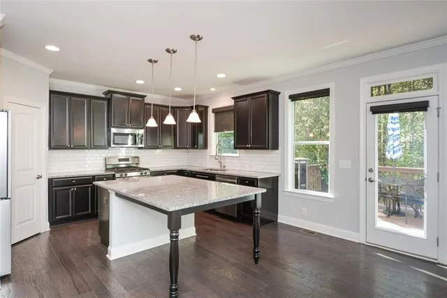 a kitchen with granite countertop stainless steel appliances and wooden cabinets
