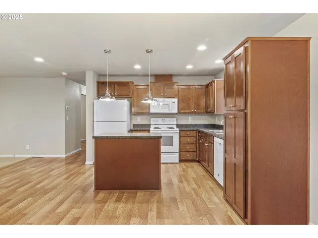 a kitchen with refrigerator and cabinets