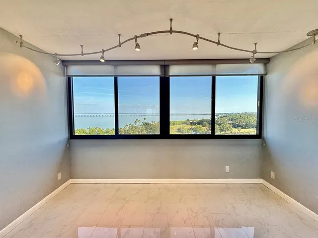 a view of a kitchen with furniture and wooden floor