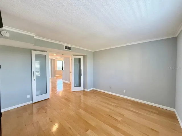 a view of a room with wooden floor and a window