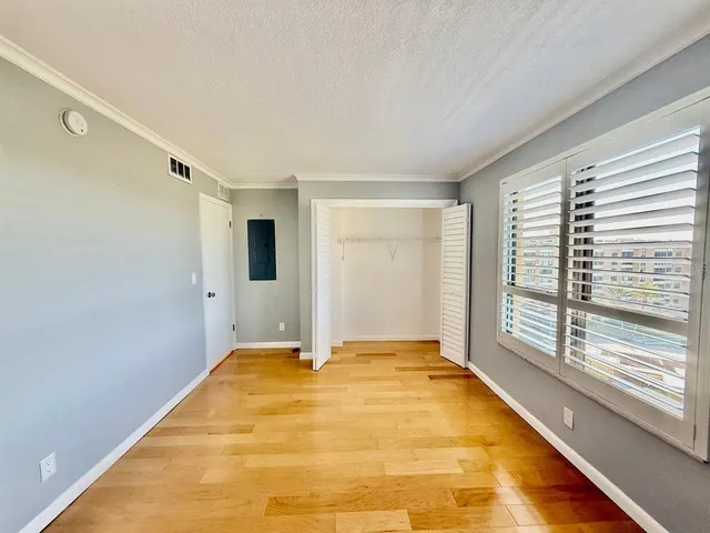 a large white room with a large mirror vanity and shower