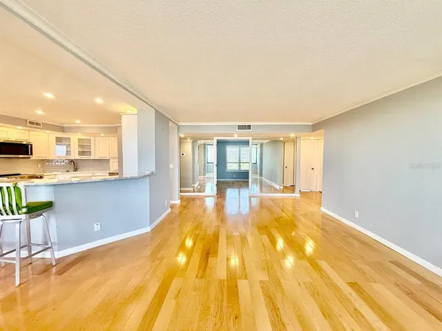 a view of a livingroom with furniture and kitchen view