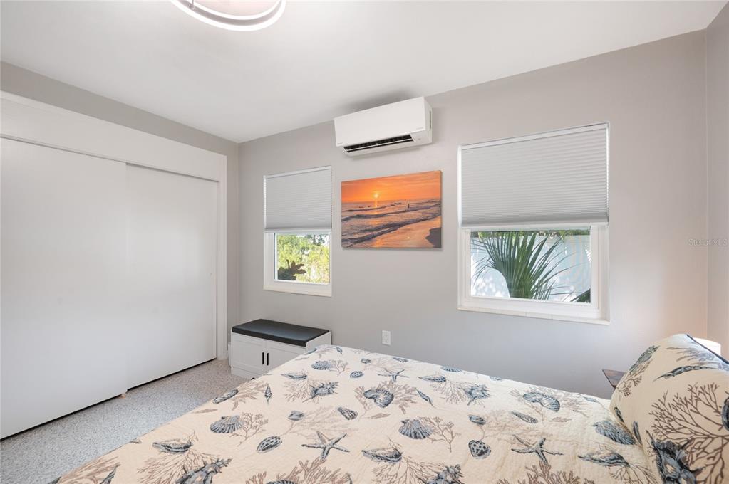 211 77th Street, Unit EAST Holmes Beach, FL 34217 - Photo 13 of 18 a bedroom with a bed and a window